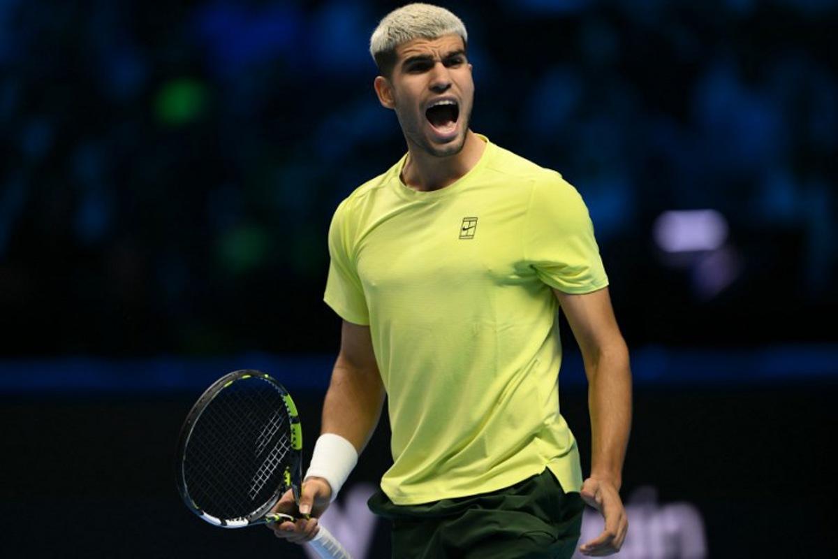 Spain's Carlos Alcaraz celebrates after winning his match against Australia's Alex De Minaur at the ATP Finals tennis tournament in Turin on November 9, 2025. Marco BERTORELLO / AFP