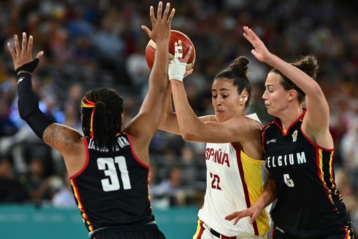 Spain's #22 Maria Conde (C) challenges Belgium's #31 Maxuella Lisowa Mbaka and Belgium's #06 Antonia Delaere (R) in the women's quarterfinal basketball match between Spain and Belgium during the Paris 2024 Olympic Games at the Bercy Arena in Paris on August 7, 2024. Aris MESSINIS / AFP