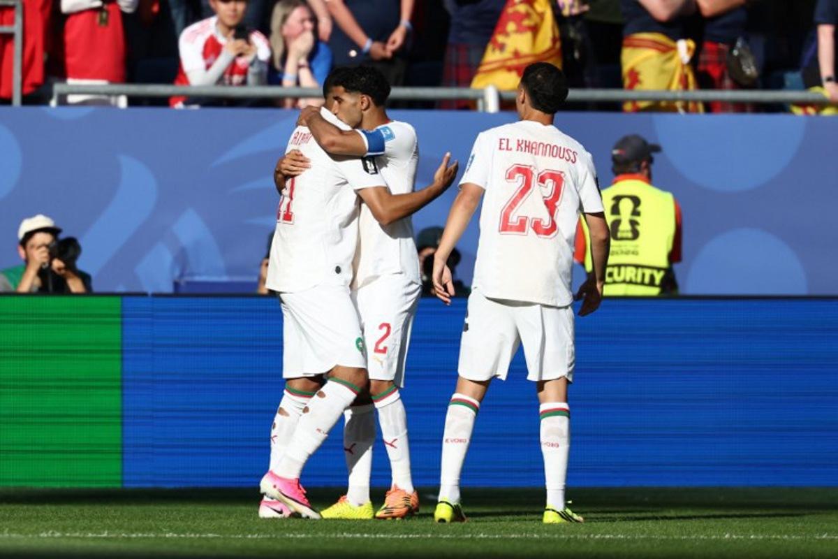 Morocco's midfielder #11 Ismael Saibari celebrates with teammates defender #02 Achraf Hakimi and midfielder #23 Bilal El Khannouss after scoring his team's first goal during the 2026 World Cup Group C football match between Scotland and Morocco at the Boston Stadium in Foxborough on June 19, 2026. FRANCK FIFE / AFP