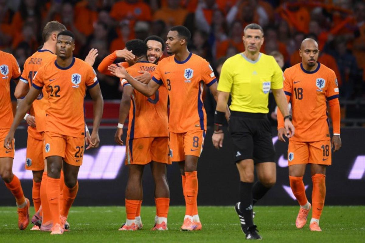 Netherlands' forward #10 Memphis Depay (4L) celebrates with teammates after scoring his team's third goal from the penalty spot during the FIFA World Cup 2026 Group G qualification football match between Netherlands and Finland, at the Johan Cruyff Arena in Amsterdam, on October 12, 2025. JOHN THYS / AFP
