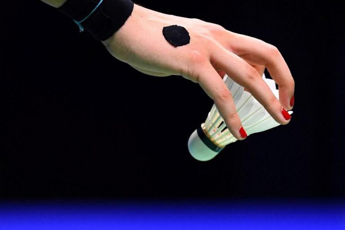 Carolina Marin of Spain holds a shuttlecock in the women's single semifinal match against He Bingjiao of China during the badminton World Championships in Nanjing, Jiangsu province on August 4, 2018. Johannes EISELE / AFP