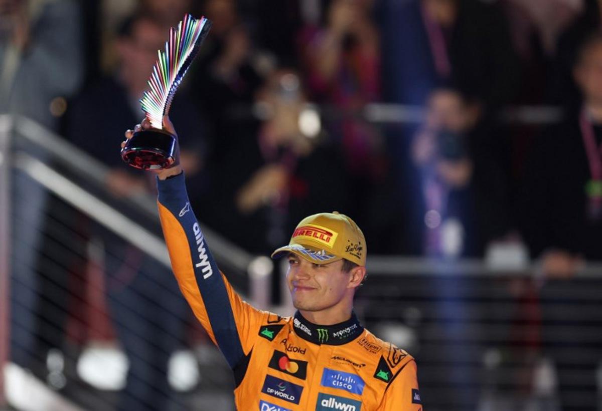 Second place finisher McLaren's British driver Lando Norris holds his trophy on the podium after the Las Vegas Formula One Grand Prix at the Las Vegas Strip Circuit in Las Vegas, Nevada, on November 22, 2025. Formula One world champion Max Verstappen produced a masterful drive to win the Las Vegas Grand Prix on Saturday as McLaren's Lando Norris finished second to edge closer to a maiden drivers' title. Red Bull ace Verstappen pounced on a slip by pole-sitter Norris on the first turn of Sin City's street circuit to grab the lead and controlled the race thereafter to claim the 69th Grand Prix win of his career, finishing more than 20 seconds clear. Patrick T. Fallon / AFP