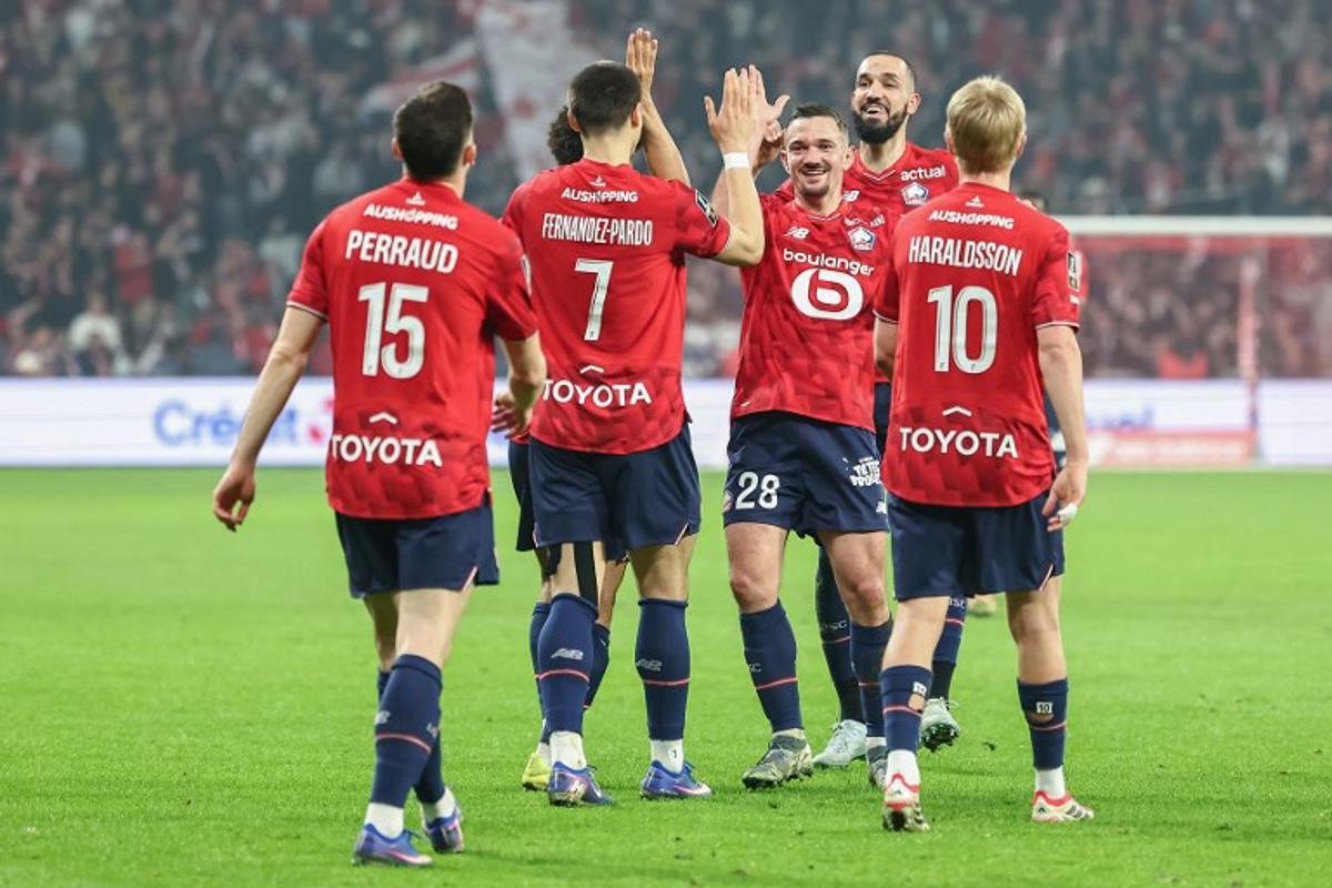 Lille's players French defender #15 Romain Perraud, Belgian forward #07 Matias Fernandez-Pardo, Algerian midfielder #06 Bentaleb Nabil, Icelandic midfielder #10 Hakon Arnar Haraldsson, Algerian midfielder #06 Nabil Bentaleb celebrate after scoring the team's first goal during the French L1 football match between Lille OSC and FC Lorient at the Stade Pierre-Mauroy in Villeneuve-d'Ascq, northern France on March 8, 2026. Sameer Al-DOUMY / AFP