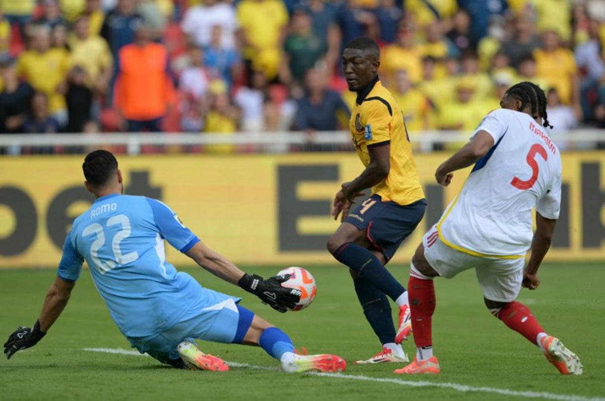 Venezuela's goalkeeper #22 Rafael Romo stops the ball past Ecuador's defender #04 Joel Ordonez (C) and Venezuela's defender #05 Christian Makoun during the 2026 FIFA World Cup South American qualifiers football match between Ecuador and Venezuela, at the Rodrigo Paz Delgado stadium in Quito, on March 21, 2025. Rodrigo BUENDIA / AFP
