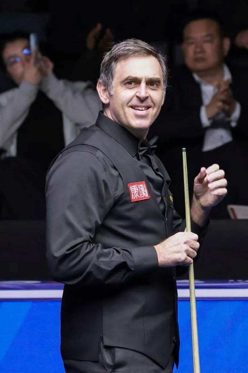Britain's Ronnie O'Sullivan reacts after making professional snooker history with the highest ever break of 153 during his match against Ryan Day of Wales at the Snooker World Open in Yushan, in China's Jiangxi province on March 20, 2026. CN-STR / AFP
