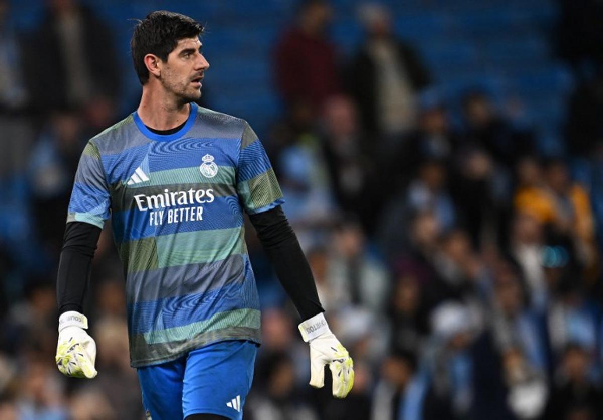 Real Madrid's Belgian goalkeeper #01 Thibaut Courtois warms up ahead of the UEFA Champions League, round of 16 second leg football match between Manchester City and Real Madrid at the Etihad Stadium in Manchester, north west England, on March 17, 2026. Paul ELLIS / AFP