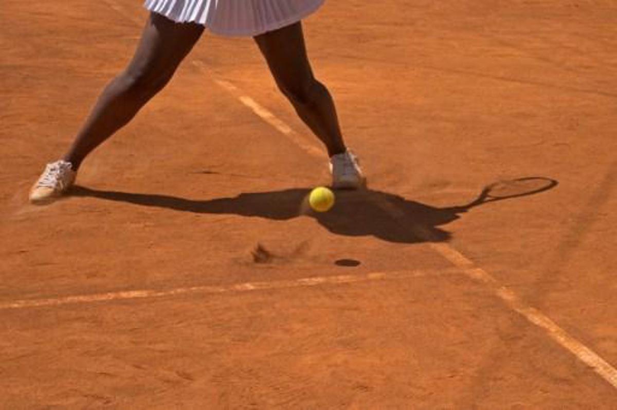 People play tennis on a clay court at ?Roland-Garros in the City?, an outdoor restaurant in New York's Battery Park June 9, 2017, where French Open matches of the men and women semi-finals and finals will be shown via live transmission on a big screen tv at the Plaza. Don Emmert / AFP