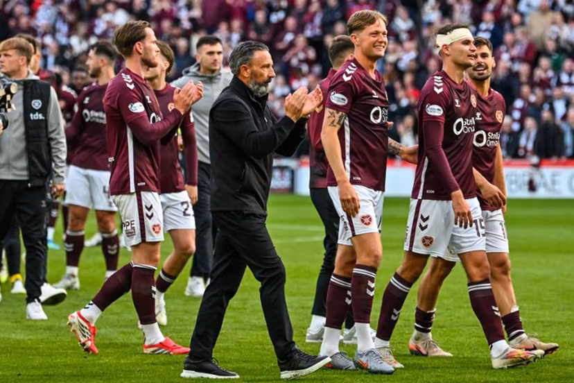 Hearts Scottish manager Derek McInnes (C) and players react after the final whistle in the Scottish Premiership football match between Hearts and Rangers at Tynecastle Stadium in Edinburgh on May 4, 2026. Hearts are hoping to become the first club other than Celtic and Rangers to win the Scottish crown since Aberdeen in 1985. ANDY BUCHANAN / AFP