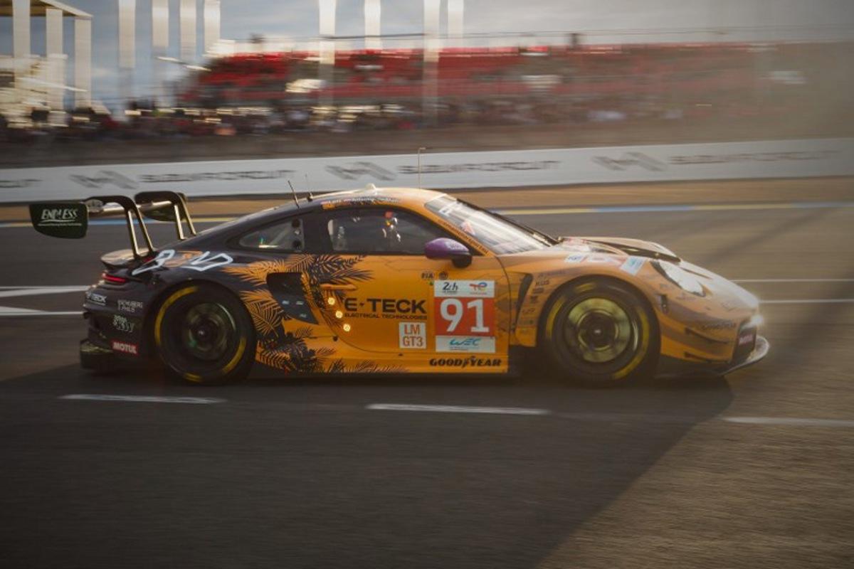 Austrian driver Richard Lietz competes in his Porsche 911 GT3 R LMGT3 as the sun sets during the Le Mans 24-hours endurance race at the Le Mans racetrack, in Le Mans, western France, on June 15, 2024. GUILLAUME SOUVANT / AFP