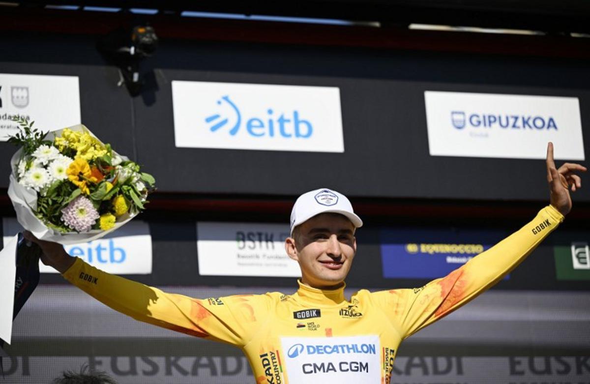 Stage winner Team Decathlon CMA CGM's French rider Paul Seixas stands on the podium wearing the Overall Ranking Leader's yellow jersey after the first stage of the Basque Country's Itzulia cycling tour, a 13.8 km time trial in Bilbao on April 6, 2026. ANDER GILLENEA / AFP
