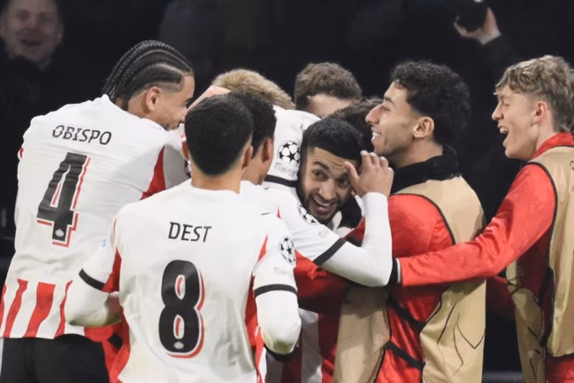 PSV Eindhoven's Moroccan midfielder #34 Ismael Saibari (3R) celebrates with teammates after scoring his team's first goal during the UEFA Champions League league phase day 8 football match between PSV Eindhoven and Bayern Munich at Philips Stadion in Eindhoven on January 28, 2026. JOHN THYS / AFP