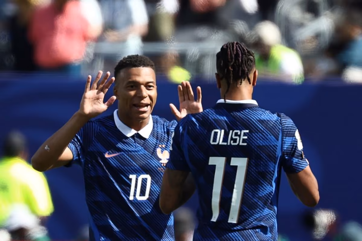 France's forward #10 Kylian Mbappe celebrates with teammate France's forward #11 Michael Olise after scoring his team's first goal during the 2026 World Cup Group I football match between France and Senegal at the New York/New Jersey Stadium in East Rutherford on June 16, 2026. FRANCK FIFE / AFP