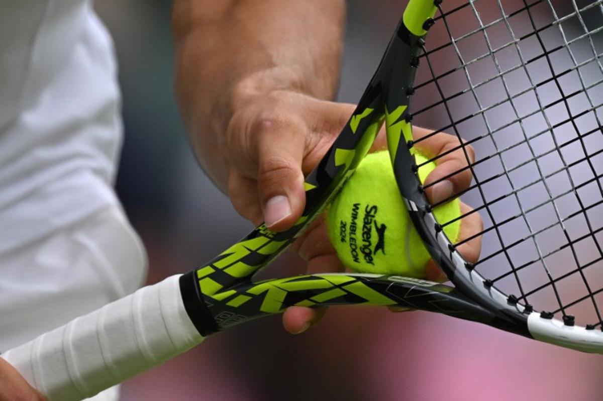 Spain's Carlos Alcaraz prepares to serve a ball against Estonia's Mark Lajal during their men's singles tennis match on the first day of the 2024 Wimbledon Championships at The All England Lawn Tennis and Croquet Club in Wimbledon, southwest London, on July 1, 2024. Glyn KIRK / AFP