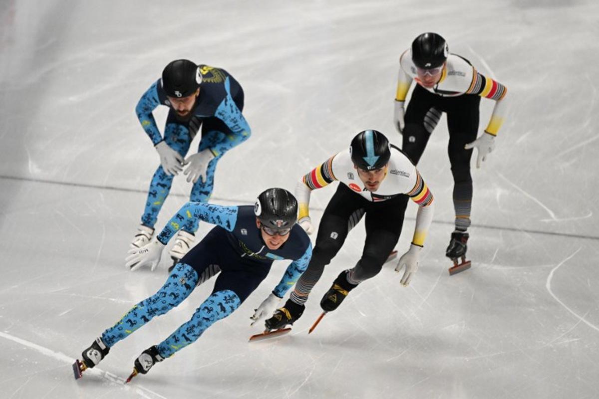Kazakhstan's Nurtilek Kazhgali (L) and Belgium's Stijn Desmet compete in the final B of the men's 5000m relay at the ISU World Cup Short Track Speed Skating event in Beijing on December 10, 2023. Jade Gao / AFP