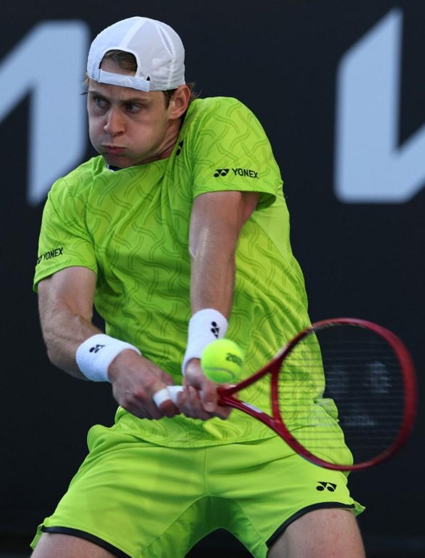 Belgium's Zizou Bergs hits a shot against Poland's Hubert Hurkacz during their men's singles match on day three of the Australian Open tennis tournament in Melbourne on January 20, 2026. IZHAR KHAN / AFP
