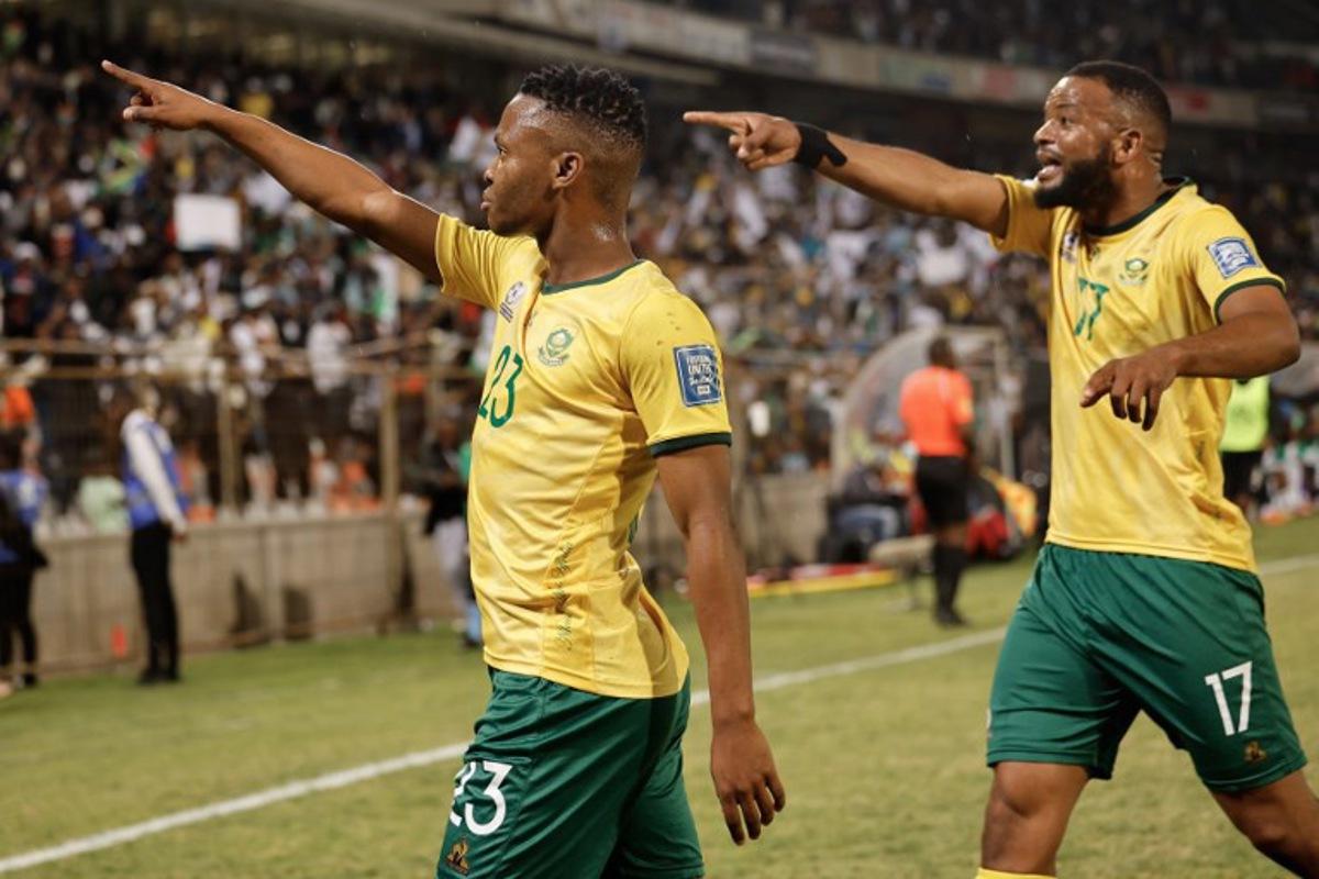 South Africa's midfielder #23 Mohau Nkota (L) celebrates after kicking a ball that lead to Nigeria's own goal during the FIFA World Cup 2026 Africa qualifiers group C match between South Africa and Nigeria at the Free State Stadium in Bloemfontein on September 9, 2025. Phill Magakoe / AFP