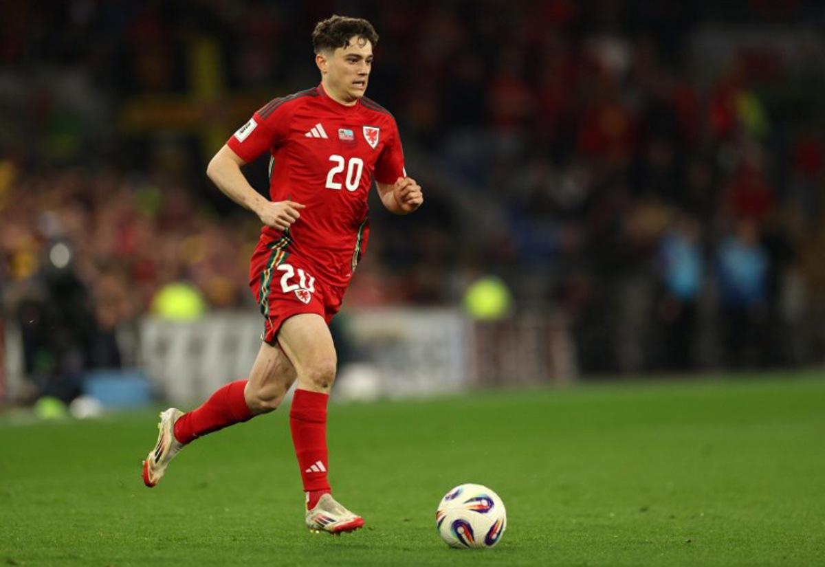 Wales' midfielder #20 Daniel James runs with the ball during the 2026 World Cup Group J qualifier football match between Wales and Kazakhstan, at Cardiff City Stadium, in Cardiff, on March 22, 2025. Adrian Dennis / AFP