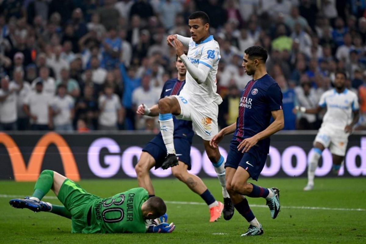 Paris Saint-Germain's French goalkeeper #30 Lucas Chevalier (L) grabs the ball in front of Marseille's English forward #10 Mason Greenwood during the French L1 football match between Olympique de Marseille (OM) and Paris Saint-Germain (PSG) at the Velodrome stadium in Marseille on September 22, 2025. Miguel MEDINA / AFP