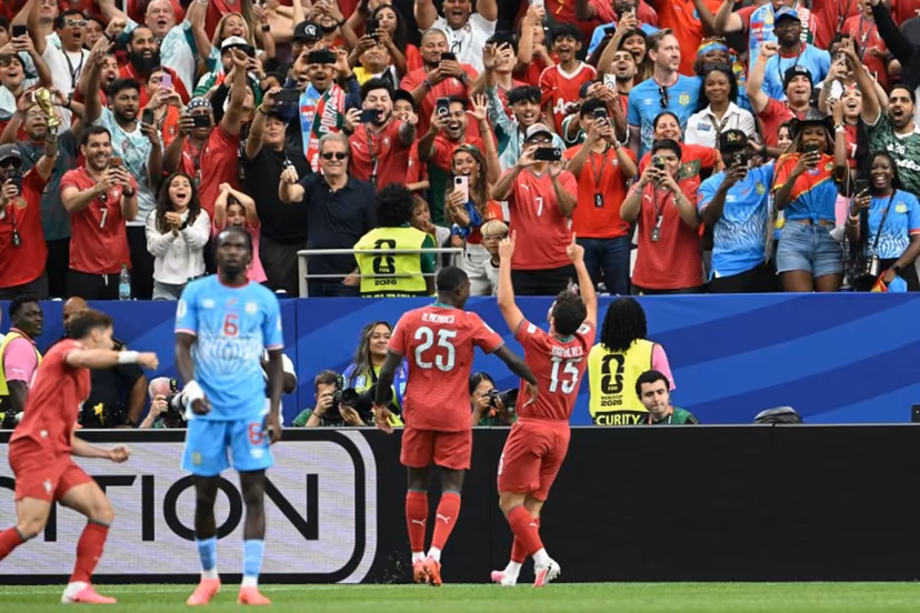 Portugal's midfielder #15 Joao Neves (R) celebrates after scoring the opening goal during the 2026 World Cup Group K football match between Portugal and the Democratic Republic of Congo at the Houston Stadium in Houston on June 17, 2026. RONALDO SCHEMIDT / AFP