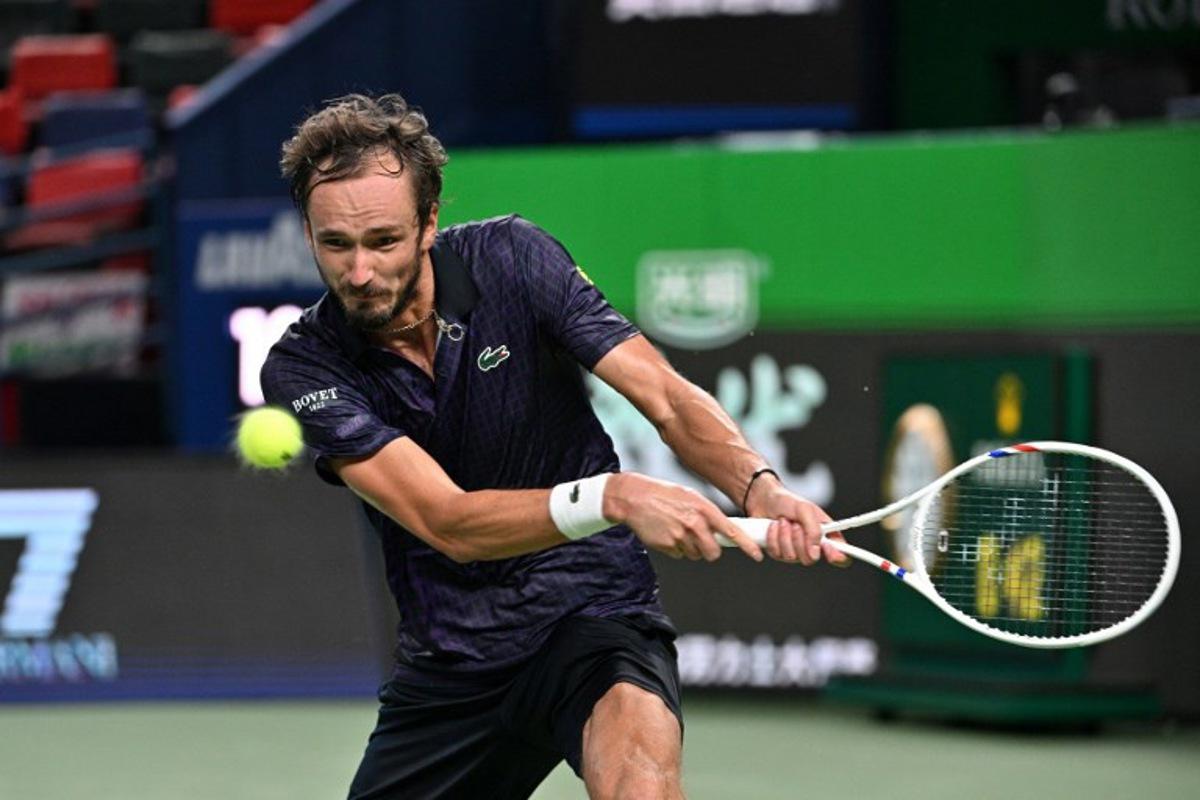 Russia's Daniil Medvedev hits a return to Australia's Alex de Minaur during their men's singles quarter-final match at the Shanghai Masters tennis tournament in Shanghai on October 10, 2025. Hector RETAMAL / AFP