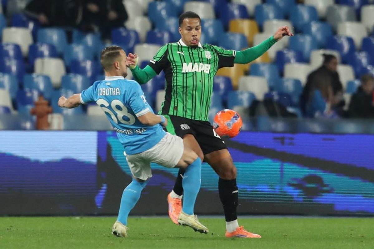 Napoli's Slovak midfielder #68 Stanislav Lobotka fights for the ball with Sassuolo's Belgian midfielder #40 Aster Vranckx during the Italian Serie A football match between Napoli and Sassuolo at the Diego Armando Maradona stadium in Naples on January 17, 2026. Carlo Hermann / AFP