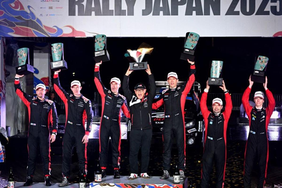 Rally Japan winners Sebastien Ogier (3rd R) and co-driver Vincent Landais (3rd L) of France pose with Toyota Gazoo Racing chairman Akio Toyoda (C) and second placed Britain's Elfyn Evans (2nd L) and his co-driver Scott Martin (L), and third placed Sami Pajari (R) and his co-driver Marko Salminen (2nd R) of Finland during the podium ceremony of the Rally Japan, the 13th round of the FIA World Rally Championships, in Toyota city, Aichi prefecture on November 9, 2025. Toshifumi KITAMURA / AFP