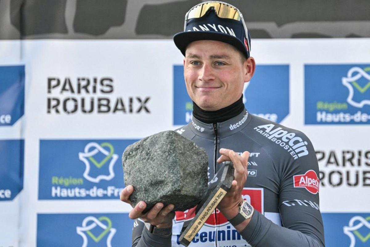 First placed Alpecin-Deceuninck's Dutch rider Mathieu van der Poel celebrates with his award on the podium of the 122nd edition of the Paris-Roubaix one-day classic cycling race, 259,2 km between Compiegne and Roubaix, northern France on April 13, 2025. Jeff PACHOUD / AFP