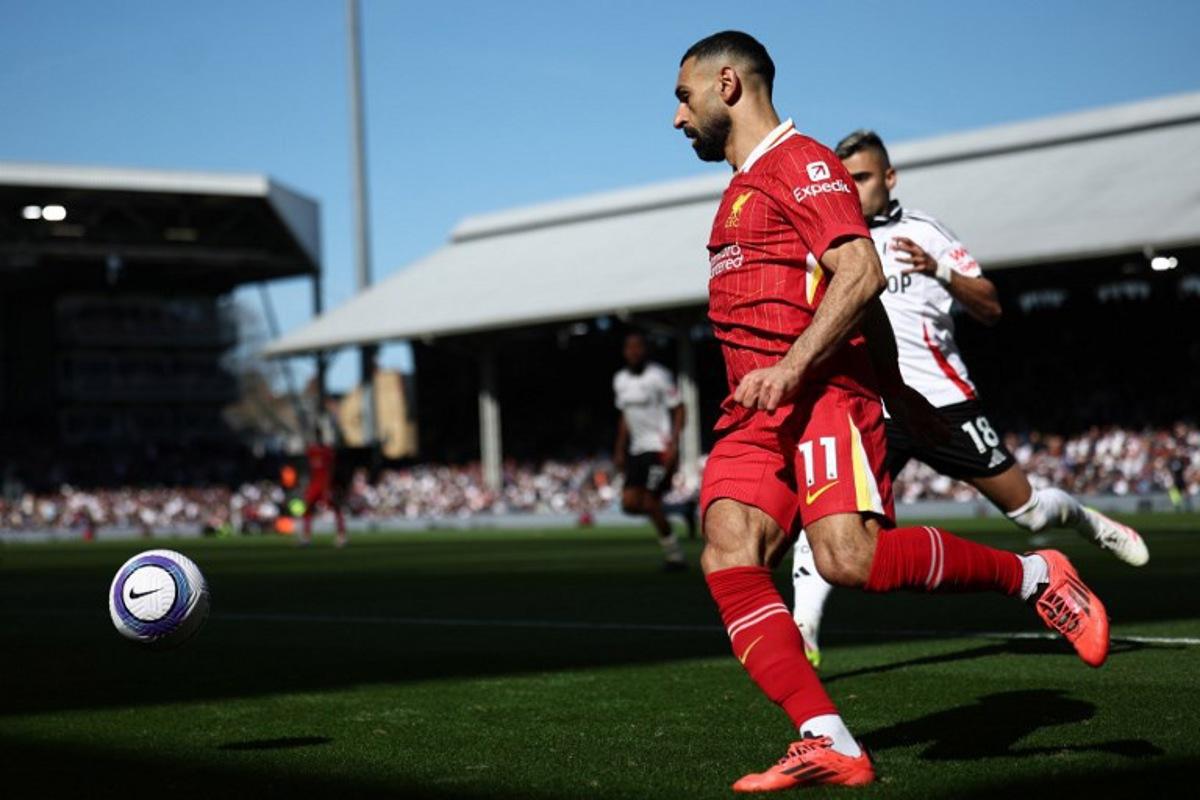 Liverpool's Egyptian striker #11 Mohamed Salah controls the ball during the English Premier League football match between Fulham and Liverpool at Craven Cottage in London on April 6, 2025. HENRY NICHOLLS / AFP