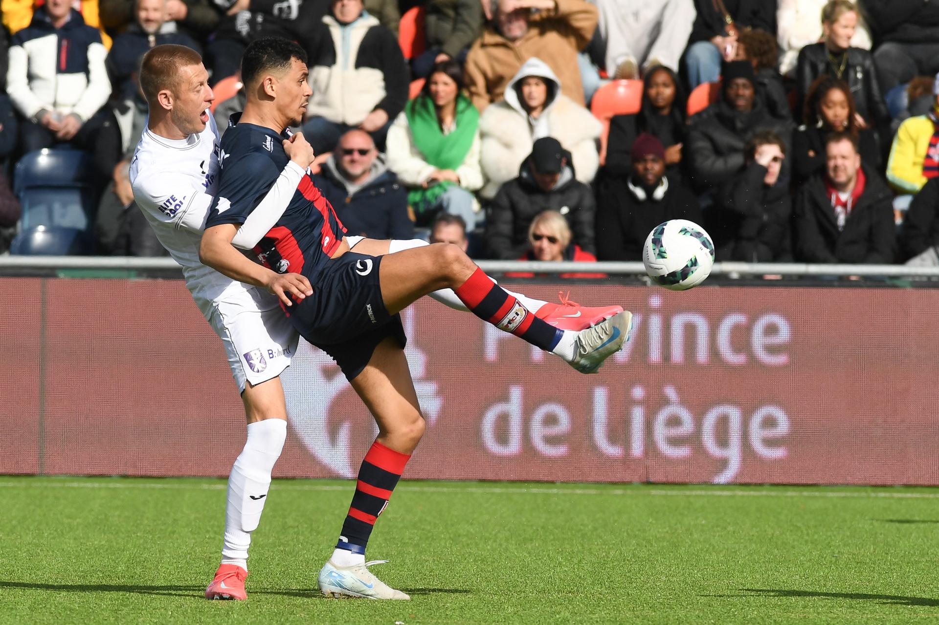 Patro Eisden's Kjetil Borry and Liege's Zakaria Atteri pictured in action during a soccer game between Patro Eisden Maasmechelen and RFC Liege, in Maasmechelen, on day 27 of the 2024-2025 'Challenger Pro League' 1B second division of the Belgian championship, Sunday 30 March 2025. BELGA PHOTO JILL DELSAUX