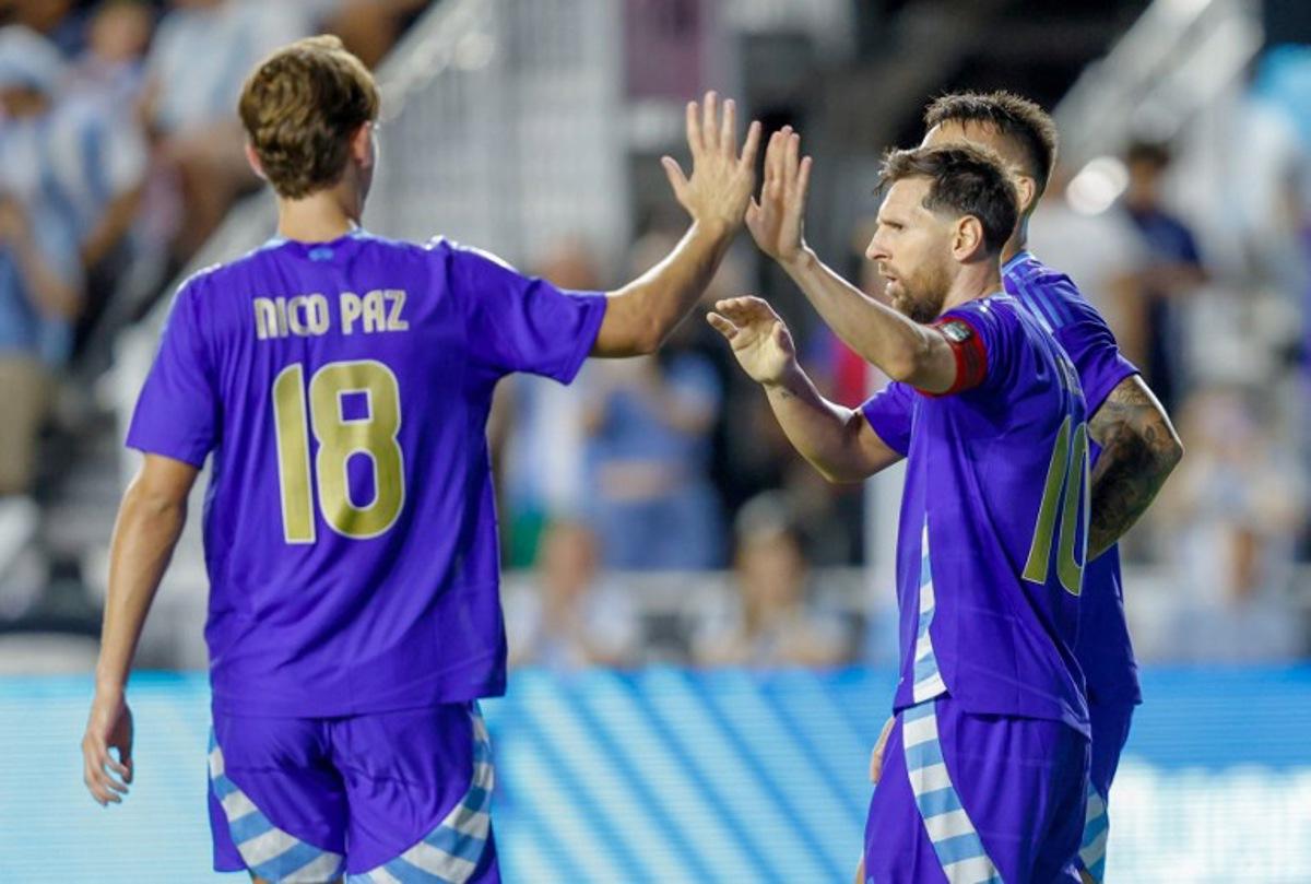 Argentina's forward #10 Lionel Messi and Argentina's midfielder #18 Nico Paz celebrate a goal during the international friendly football match between Argentina and Puerto Rico at Chase Stadium in Fort Lauderdale, Florida, on October 14, 2025. Chris Arjoon / AFP