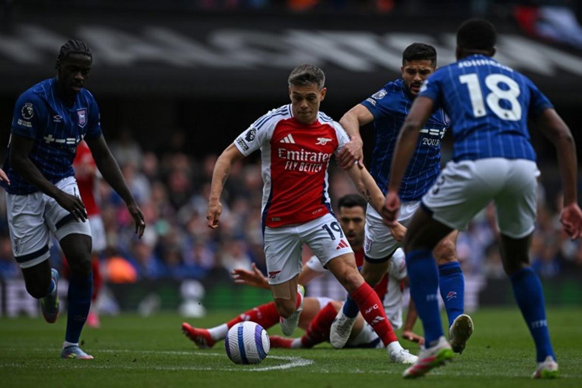 Arsenal's Belgian midfielder #19 Leandro Trossard (C) runs with the ball during the English Premier League football match between Ipswich Town and Arsenal at Portman Road in Ipswich, eastern England on April 20, 2025. Ben STANSALL / AFP