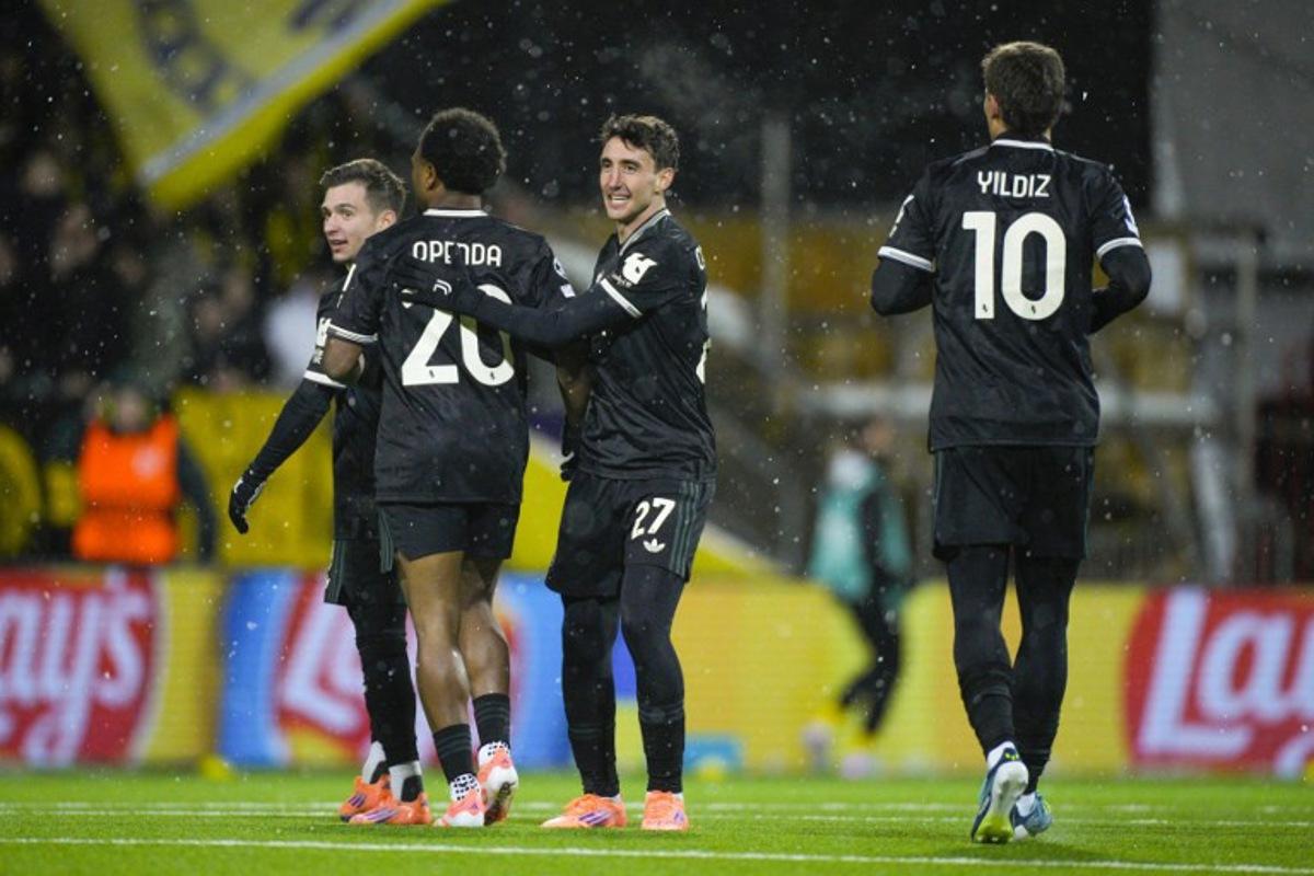 Juventus' Belgian forward #20 Lois Openda (L) celebrates with Juventus' Italian defender #27 Andrea Cambiaso celebrates after scoring the equalising goal during the UEFA Champions League football match between Bodoe/Glimt and Juventus Turin in Bodoe, on November 25, 2025. Stian Lysberg Solum / NTB / AFP
