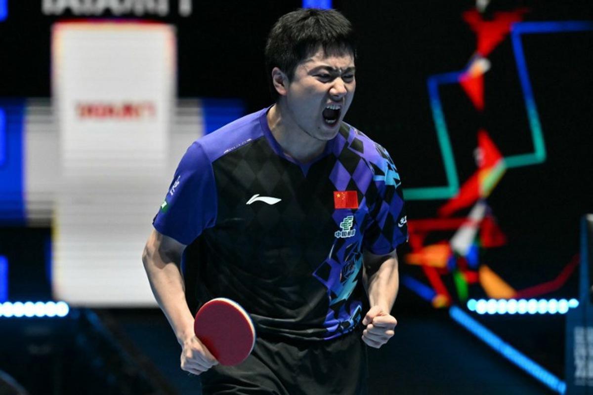 China's Liang Jingkun celebrates winning a game against France's Alexis Lebrun during their Men's Teams semi-final match at the ITTF World Table Tennis Championships in Wembley Arena, west London on May 9, 2026. Glyn KIRK / AFP