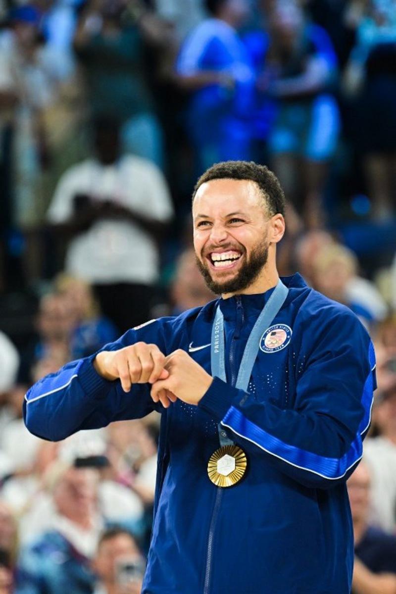 Gold medallist USA's #04 Stephen Curry poses on the podium after the men's Gold Medal basketball match between France and USA during the Paris 2024 Olympic Games at the Bercy Arena in Paris on August 10, 2024. Damien MEYER / AFP