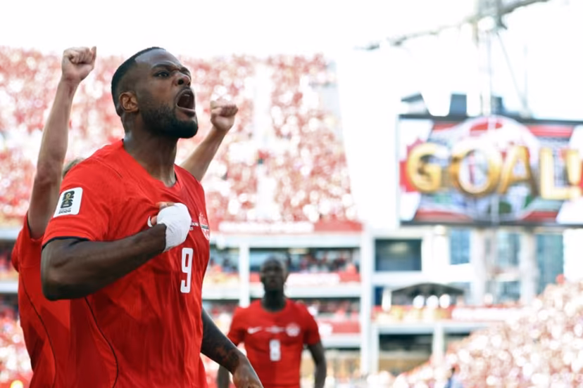 Canada's forward #09 Cyle Larin (R) celebrates after scoring a goal during the 2026 World Cup Group B football match between Canada and Bosnia and Herzegovina at the Toronto Stadium in Toronto on June 12, 2026. Cole Burston / AFP