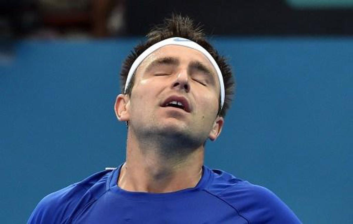 Marinko Matosevic of Australia reacts while playing against Steve Johnson of the US during their men's singles match on day three of the Brisbane International tennis tournament in Brisbane on January 6, 2015. AFP PHOTO / Saeed KHAN IMAGE RESTRICTED TO EDITORIAL USE - STRICTLY NO COMMERCIAL USE IMAGE RESTRICTED TO EDITORIAL USE - STRICTLY NO COMMERCIAL USE