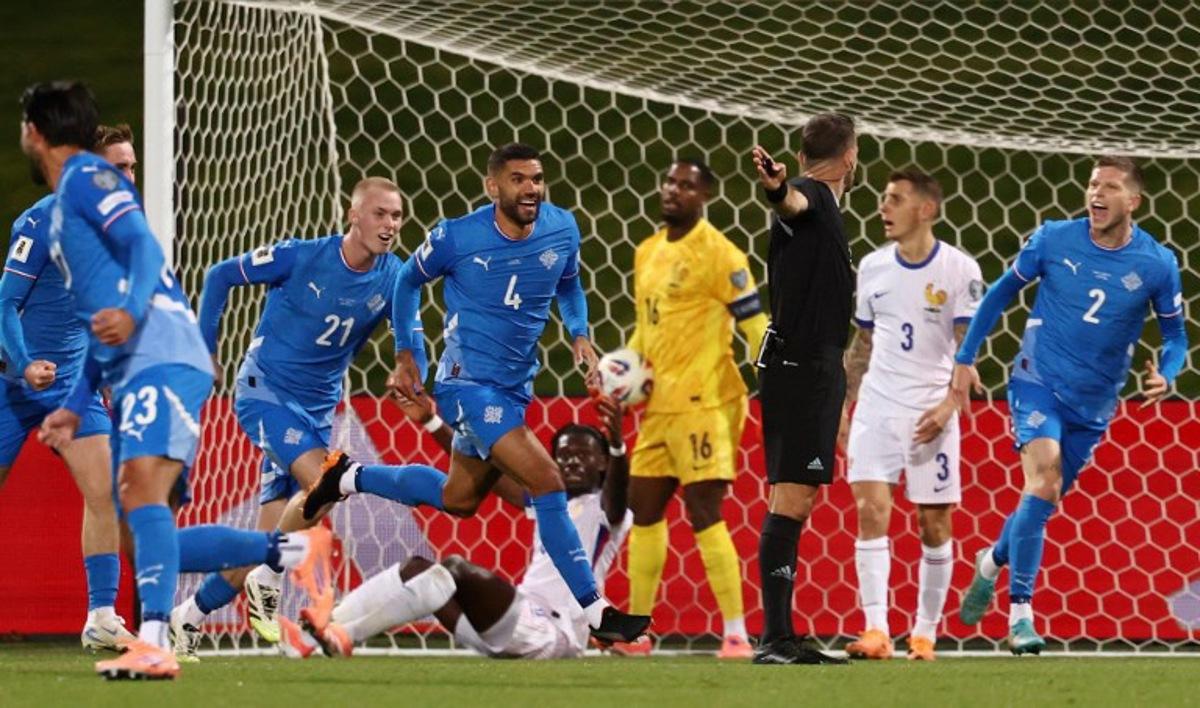 Iceland's defender #04 Victor Palsson (C) celebrates scoring his team's first goal with teammates during the 2026 World Cup qualifying round Group D football match between Iceland and France at the Laugardalsvollur Stadium in Reykjavik on October 13, 2025. FRANCK FIFE / AFP