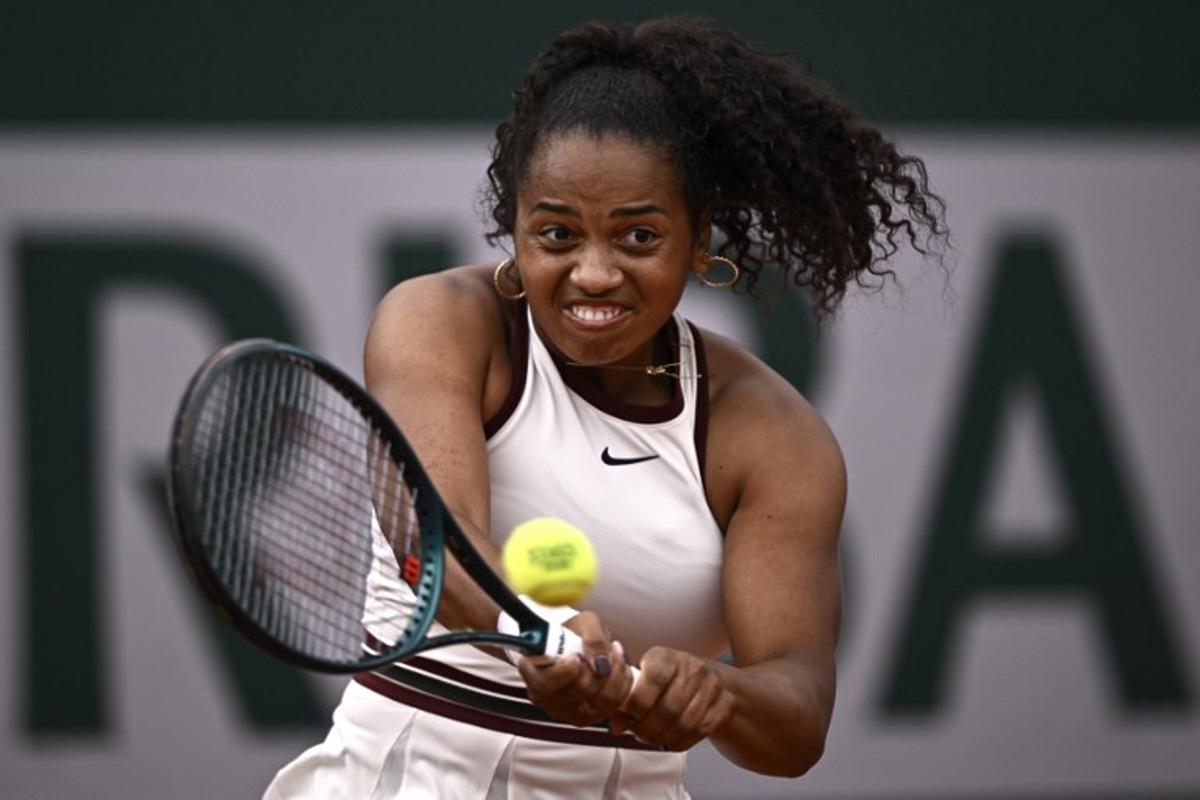 US Robin Montgomery plays a backhand return to France's Diane Parry during their women's singles match on day 2 of the French Open tennis tournament at the Roland-Garros Complex in Paris on May 26, 2025. JULIEN DE ROSA / AFP