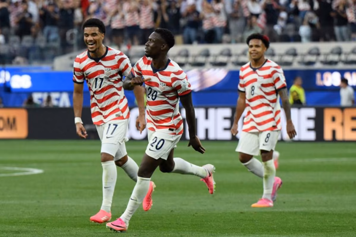 US forward #20 Folarin Balogun (C) celebrates scoring his team's third goal during the 2026 World Cup Group D football match between USA and Paraguay at the Los Angeles Stadium in Inglewood on June 12, 2026. Patrick T. Fallon / AFP