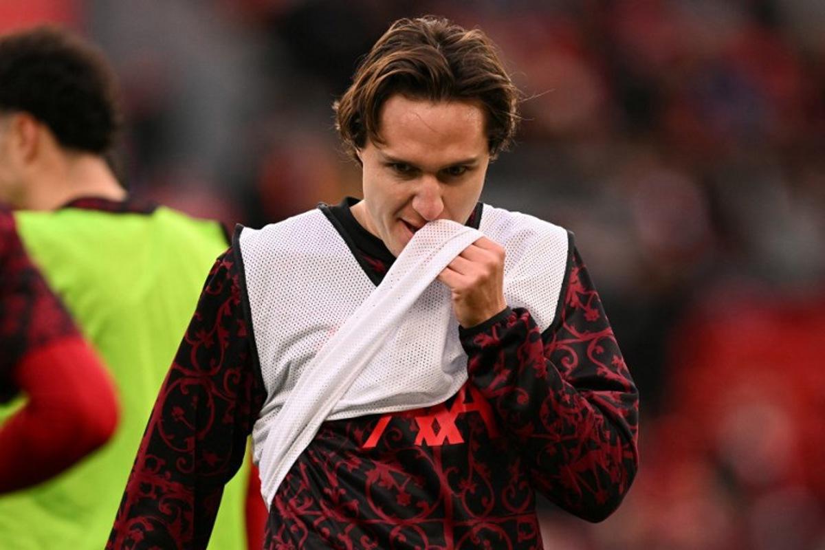 Liverpool's Italian striker #14 Federico Chiesa warm up ahead of the English Premier League football match between Liverpool and Wolverhampton Wanderers at Anfield in Liverpool, north west England on December 27, 2025. Oli SCARFF / AFP