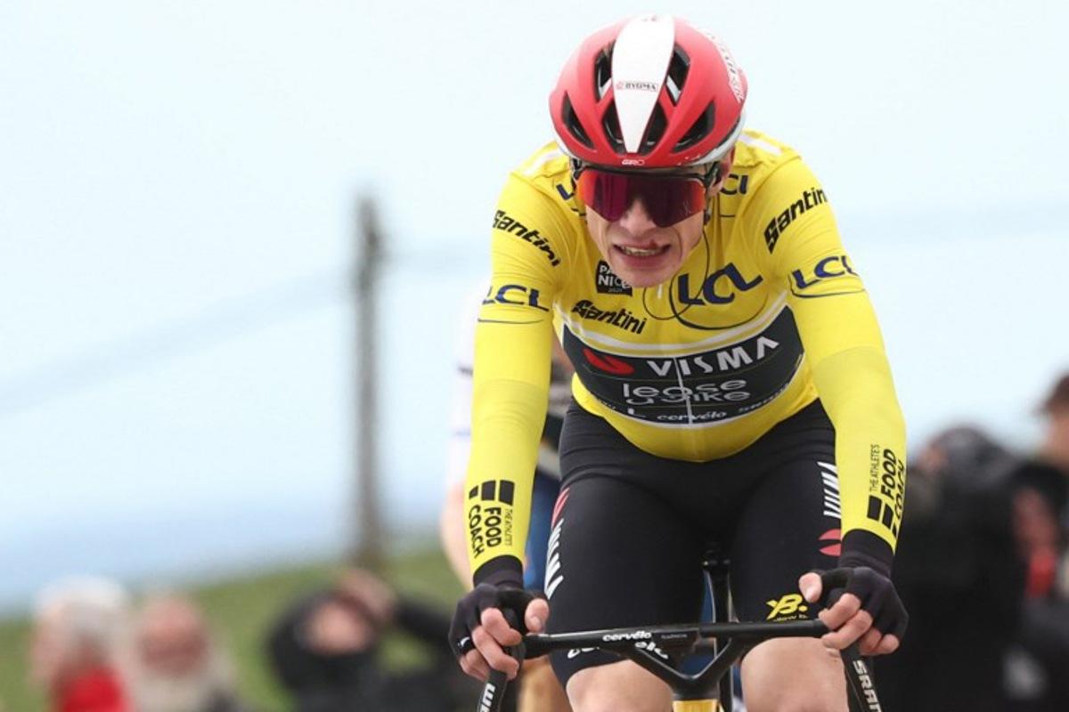 (FILES) Team Visma-Lease a Bike's Danish rider Jonas Vingegaard wearing the overall leader's yellow jersey reacts as he crosses the finish line of the 5th stage of the Paris-Nice cycling race, 203,3 km between Saint-Just-en-Chevalet and La Côte-Saint-André, on March 13, 2025. Two-time Tour de France winner Jonas Vingegaard withdrew from the Paris-Nice race before the start of the sixth stage on March 14, 2025, after injuring his hand in a fall. The Visma-Lease a Bike team said that its medical team had decided it was better that the Danish rider recovers at home and focus on upcoming goals. Anne-Christine POUJOULAT / AFP