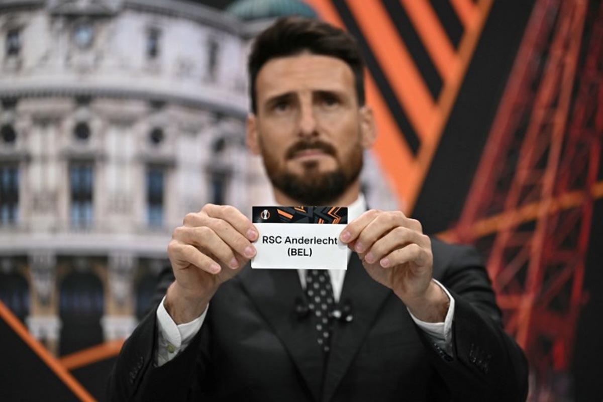 Former Spanish player Artiz Aduriz holds the paper slip of RSC Anderlecht during the 2024-2025 UEFA Europa League football tournament knockout play-off draw at the House of European Football in Nyon, on January 31, 2025. Fabrice COFFRINI / AFP
