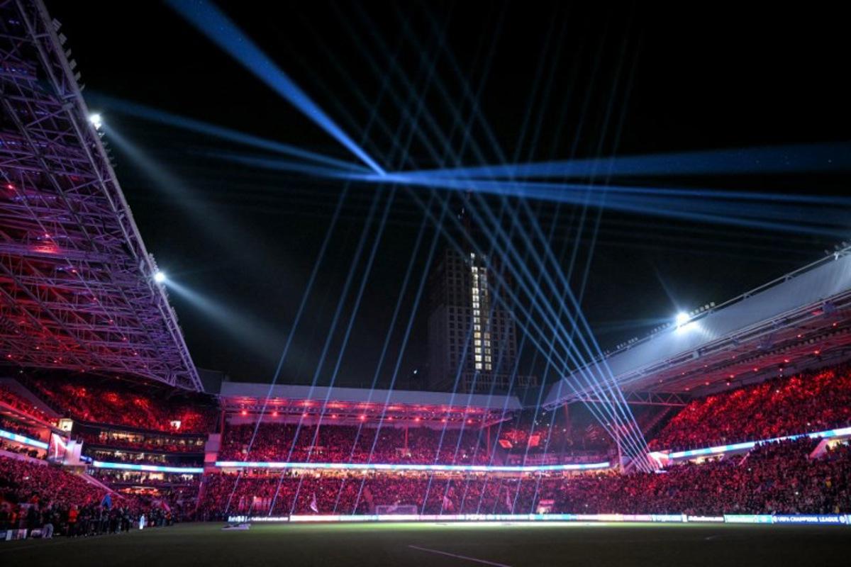 This photograph shows the stadium light show prior to the UEFA Champions League knockout phase play-off 2nd leg football match between PSV Eindhoven and Juventus at the Philips Stadion in Eindhoven on February 19, 2025. NICOLAS TUCAT / AFP