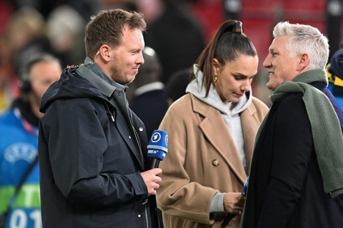 (From L) Germany's head coach Julian Nagelsmann and Germany's former football player Bastian Schweinsteiger speak during an interview prior to the international friendly football match between Germany and Ghana in Stuttgart, southwestern Germany on March 30, 2026. THOMAS KIENZLE / AFP