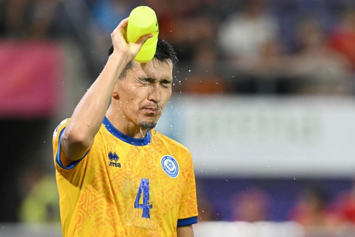 Kazakhstan's defender #04 Ular Zhaksybayev sprays water on his head during the FIFA World cup 2026 1st round day 6, Group J qualification football match between Belgium and Kazakhstan, at the Lotto Park stadium in Anderlecht, Brussels Capital Region, on September 7, 2025. NICOLAS TUCAT / AFP