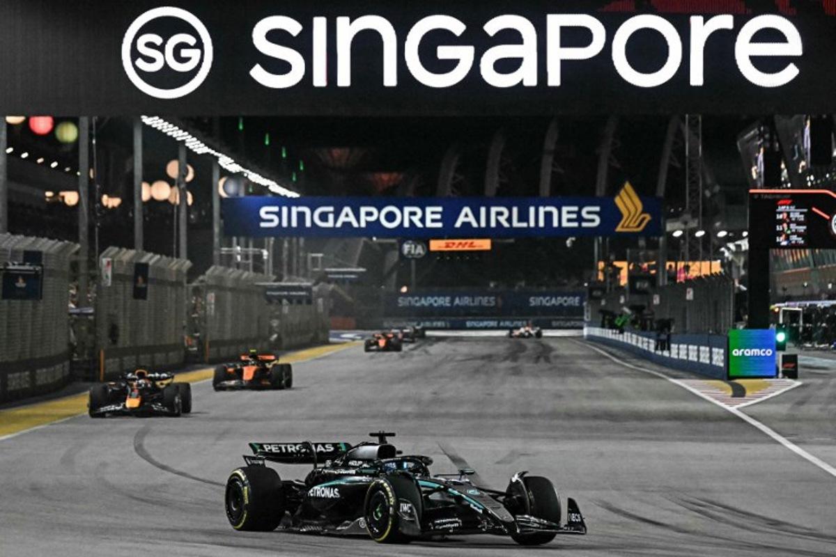 Mercedes' British driver George Russell leads ahead of Red Bull Racing's Dutch driver Max Verstappen during the Formula One Singapore Grand Prix night race at the Marina Bay Street Circuit in Singapore on October 5, 2025. Lillian SUWANRUMPHA / AFP