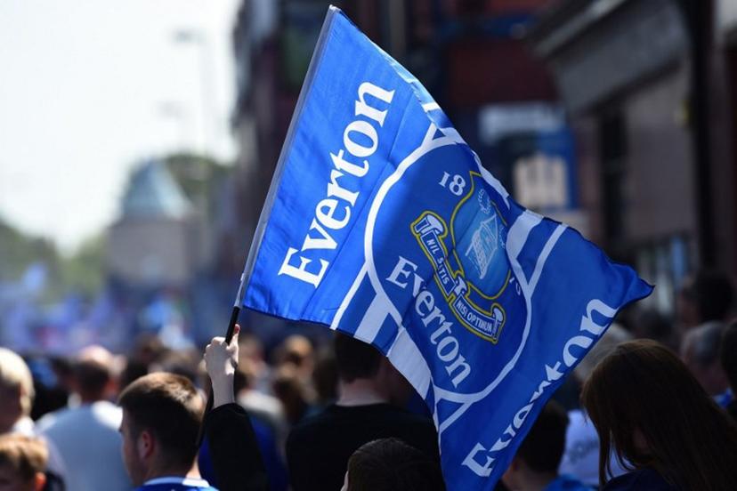 Everton supporters wave the club's flag before the start of the English Premier League football match between Everton and Bournemouth at Goodison Park in Liverpool, north west England on May 28, 2023. PETER POWELL / AFP