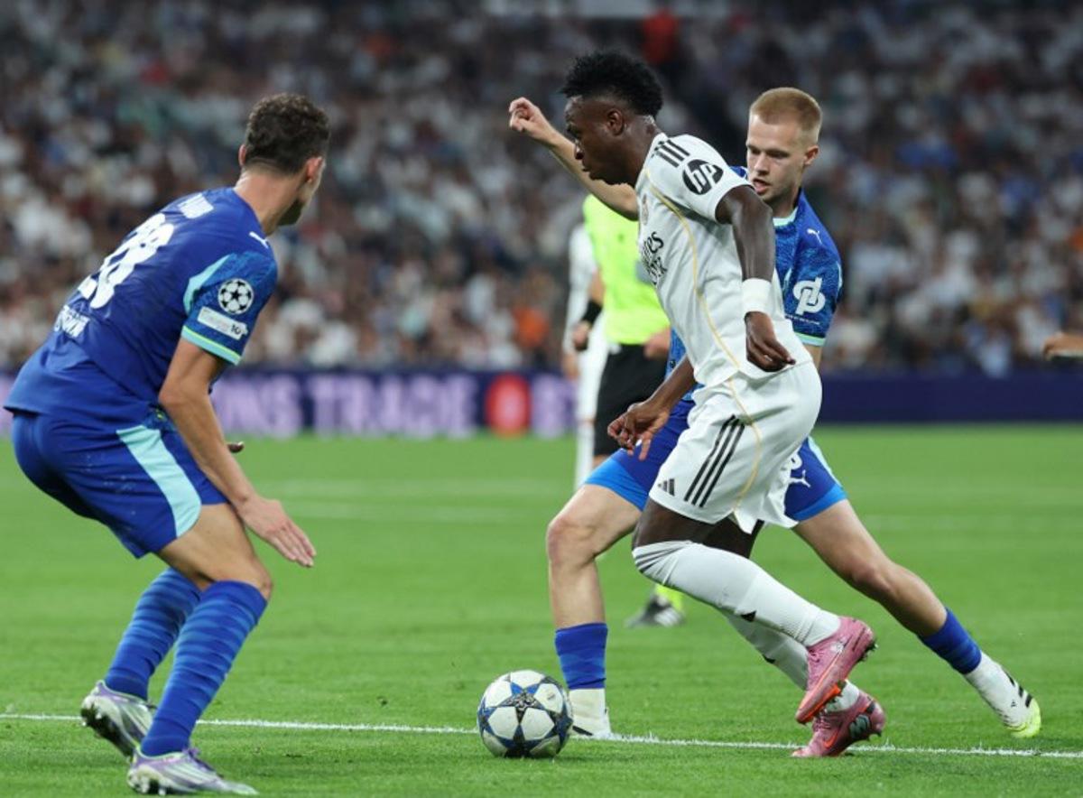 Real Madrid's Brazilian forward #07 Vinicius Junior fights for the ball with Marseille's Belgian midfielder #18 Arthur Vermeeren during the UEFA Champions League first round day 1 football match between Real Madrid CF and Olympique de Marseille at the Santiago Bernabeu stadium in Madrid on September 16, 2025. Thomas COEX / AFP