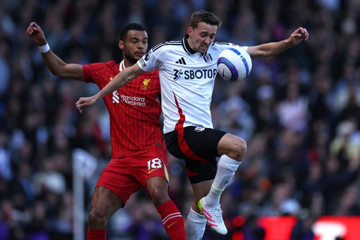 Liverpool's Dutch striker #18 Cody Gakpo (L) vies with Fulham's Belgian defender #21 Timothy Castagne (R) during the English Premier League football match between Fulham and Liverpool at Craven Cottage in London on April 6, 2025. HENRY NICHOLLS / AFP