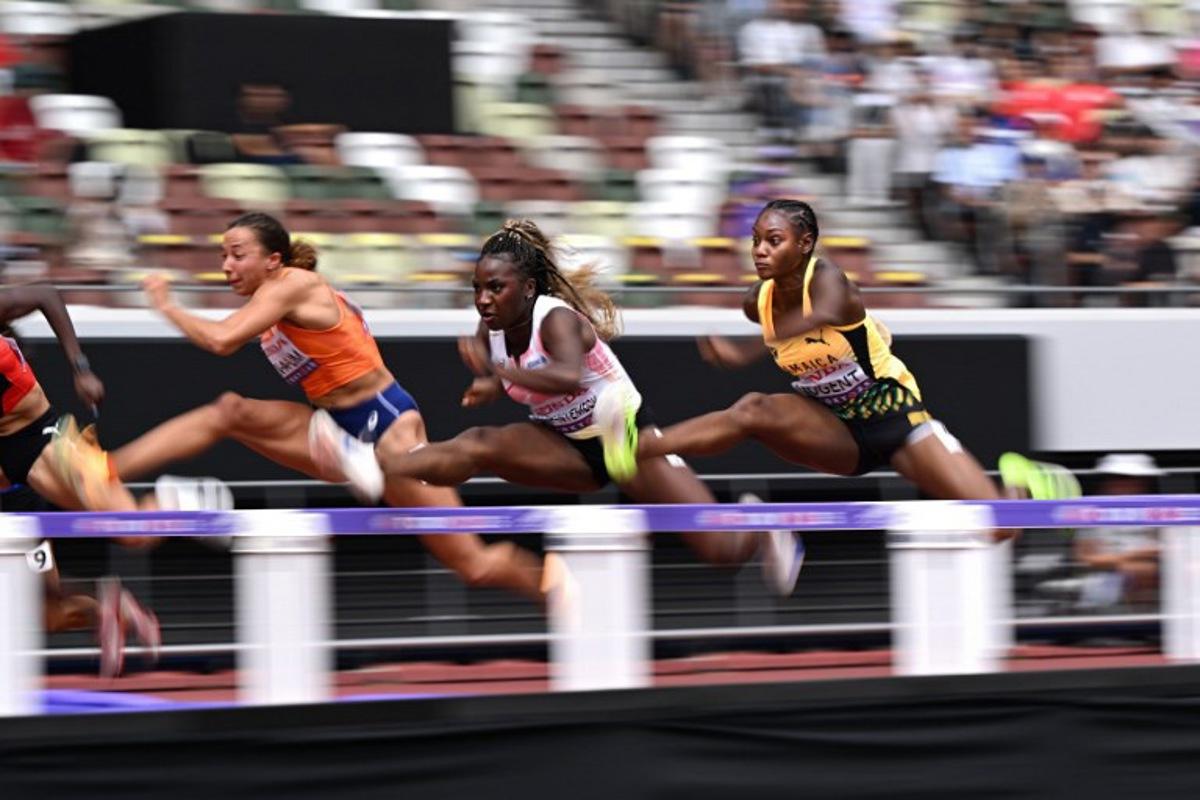 (L-R) Netherlands' athlete Maayke Tjin-A-Lim, Belgium's athlete Yanla Ndjip-Nyemeck, and Jamaica's athlete Ackera Nugent compete in the women's 100m hurdles heats during the World Athletics Championships in Tokyo on September 14, 2025. Kirill KUDRYAVTSEV / AFP